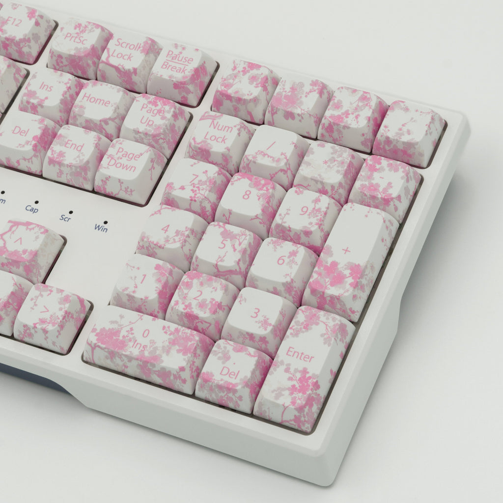 Pink Blossom keycaps featuring delicate floral designs. Left side close up.  Right side close up.