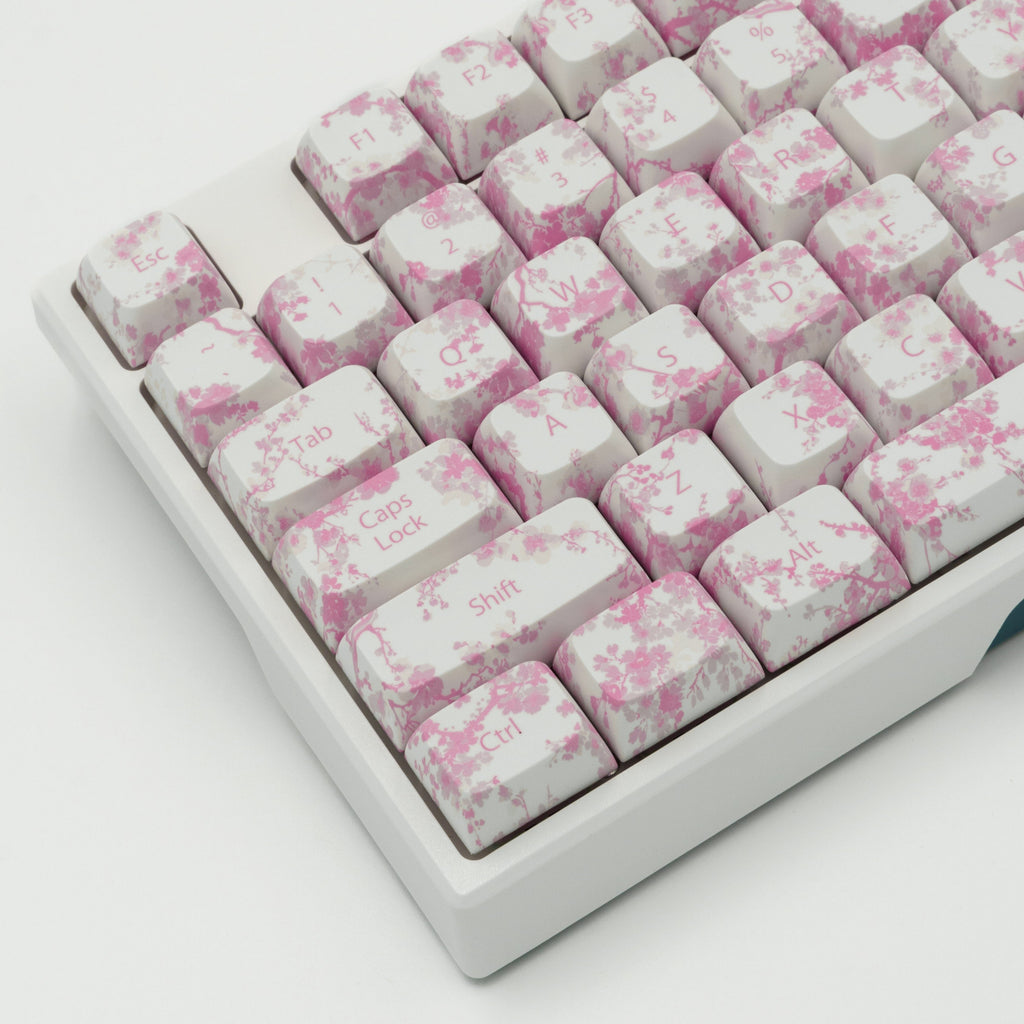 Pink Blossom keycaps featuring delicate floral designs. Left side close up. Left side angle view.