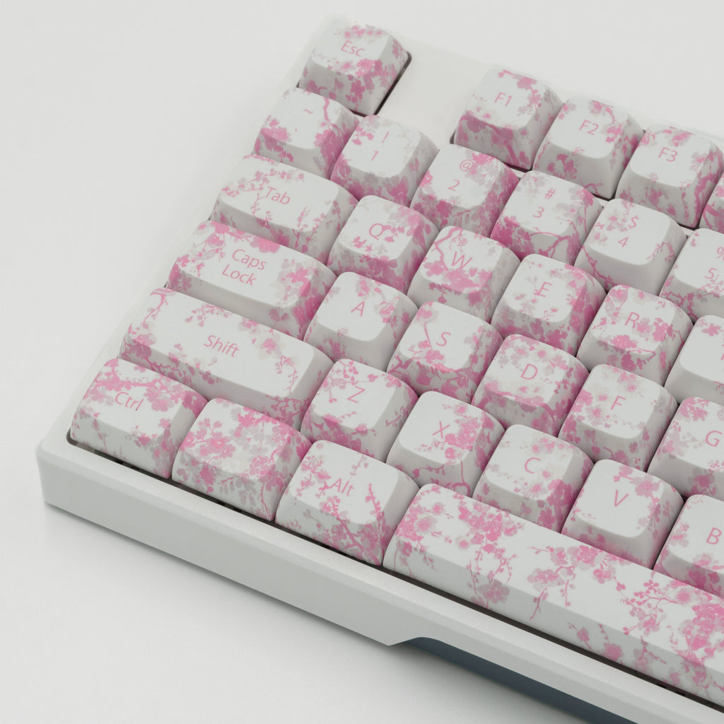 Pink Blossom keycaps featuring delicate floral designs. Left side close up. 