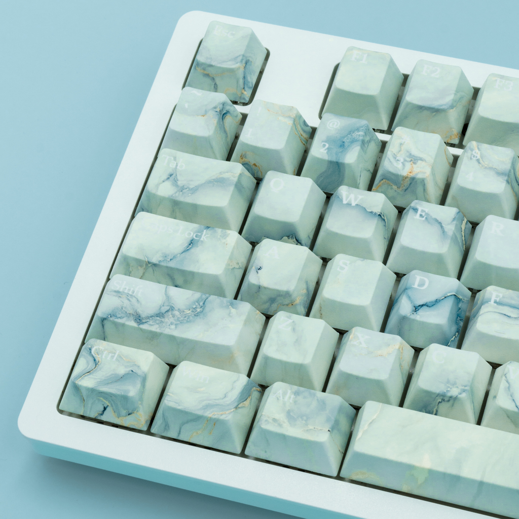 Arctic Marble Keycaps, featuring blue and white color scheme. Inspired by the Arctic landscape and Marble stone. Close up left side ariel view.  